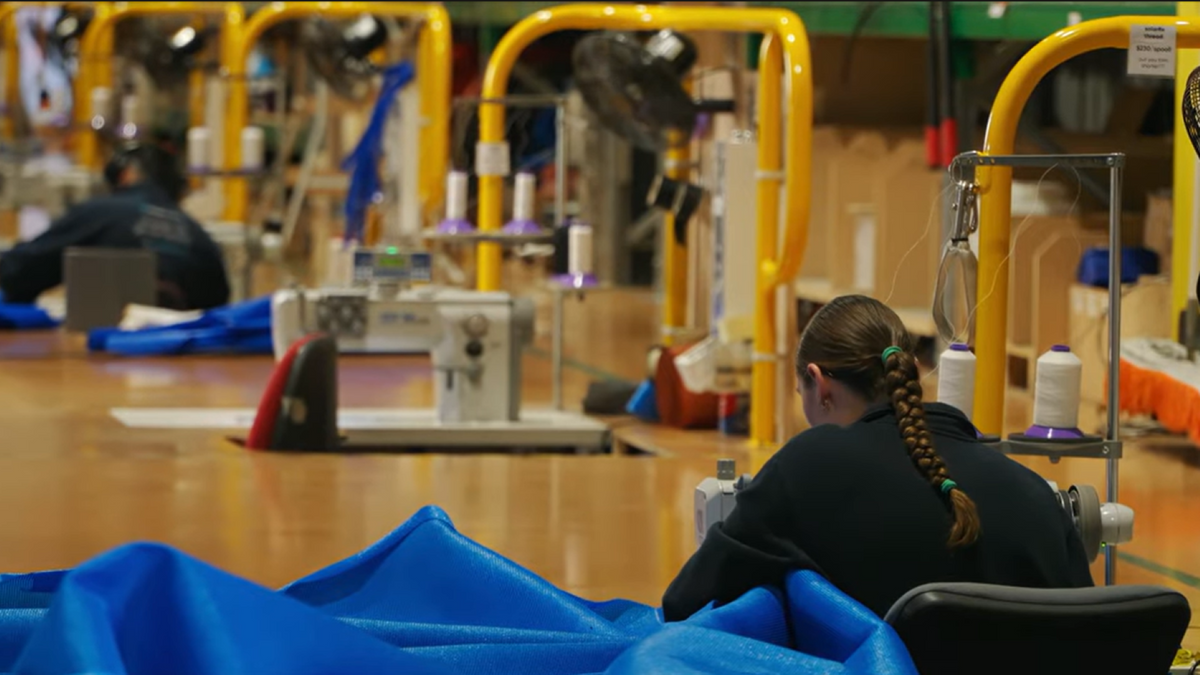 ShadeSpace team member sewing Shade Sail fabric in the Dargaville workshop.